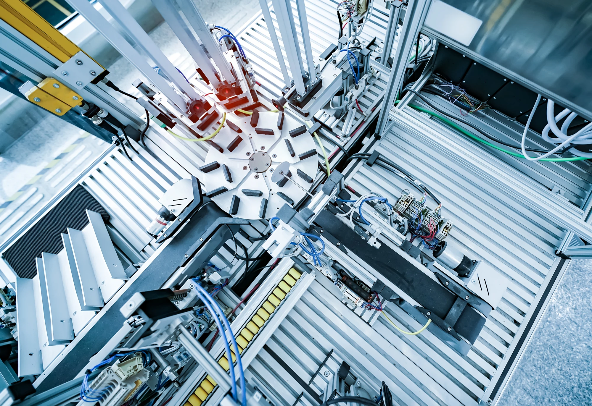 Automated inspection and assembly equipment with fixtures, linear axes, sensors and pneumatic components, used as an industry illustration