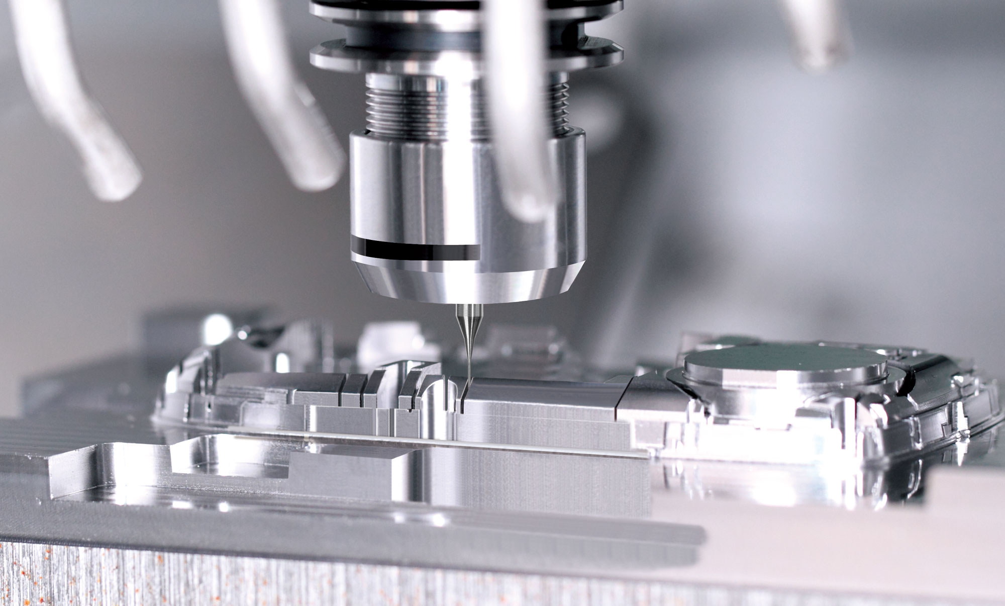 Precision machining of a phone-housing mold, representative industry photograph